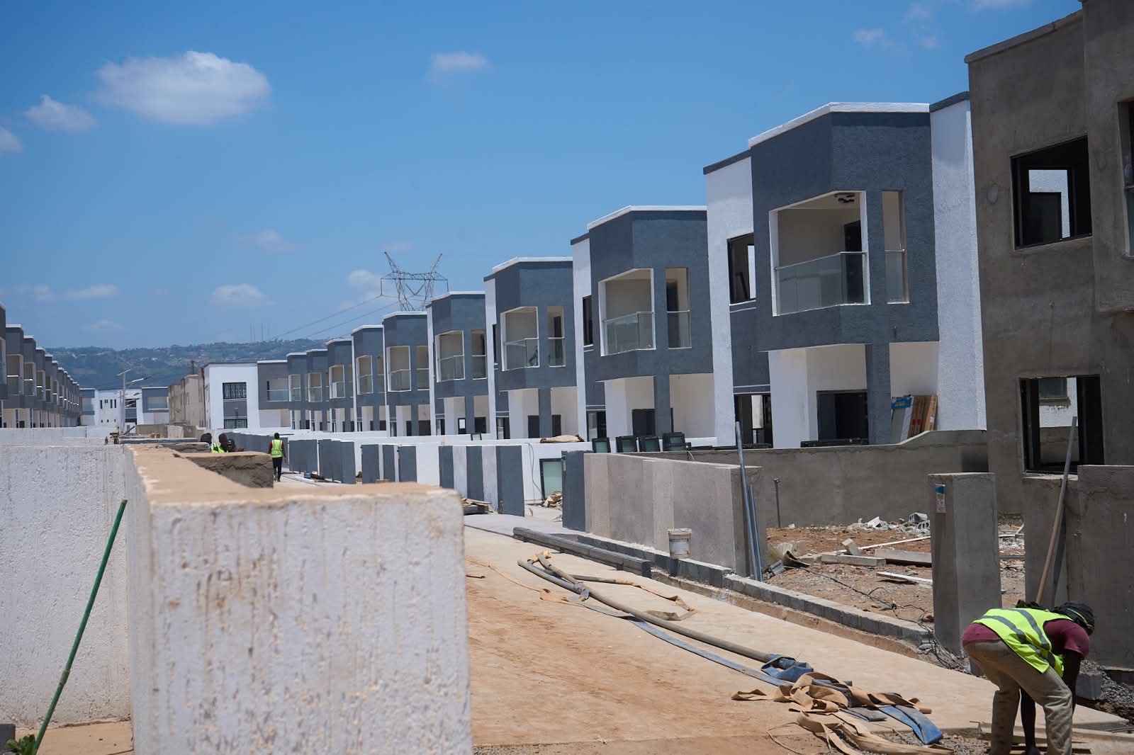 Homes under construction, with finished homes further down the street