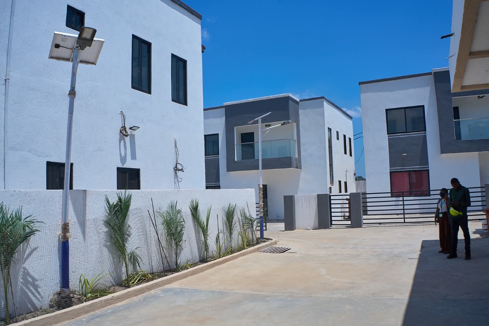 Finished homes around a paved courtyard