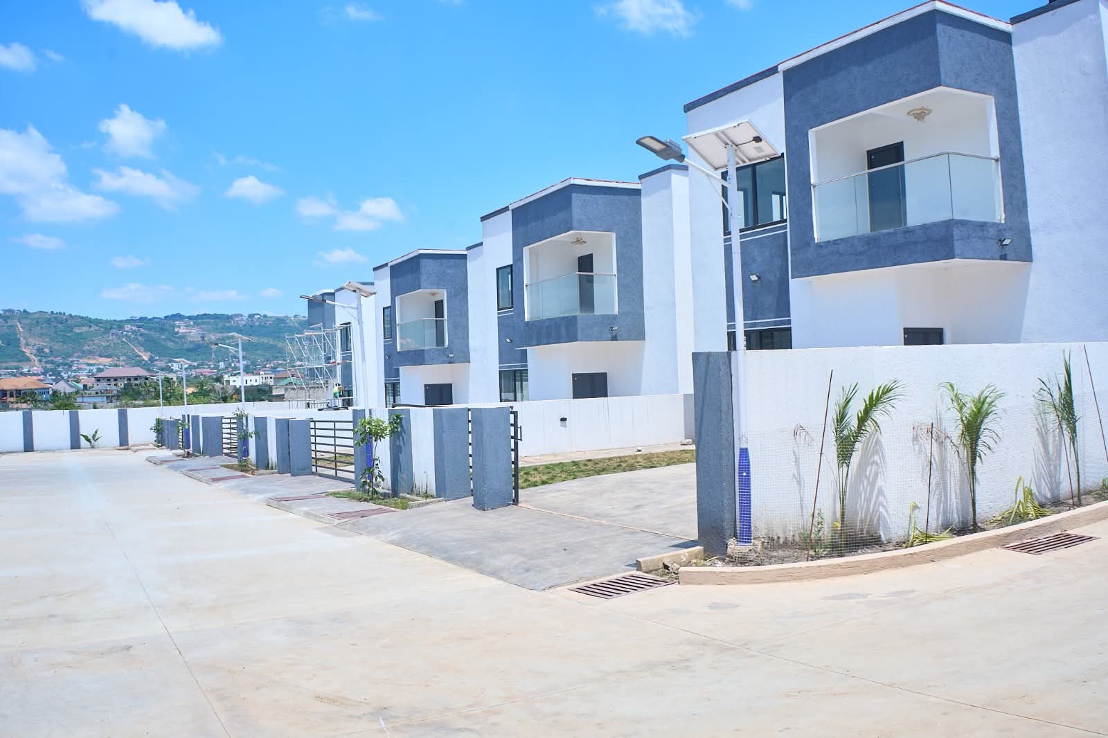 Finished homes with solar street lights and hills in the distance